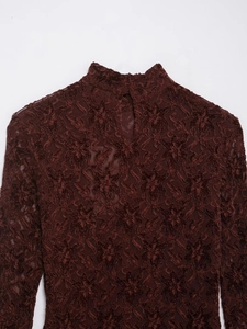 Detail of burgundy floral lace dress with high neck and keyhole cutout design