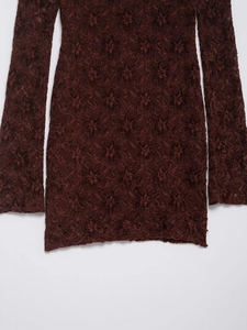 Detailed macro view of deep burgundy lace fabric with intricate star floral crochet patterns