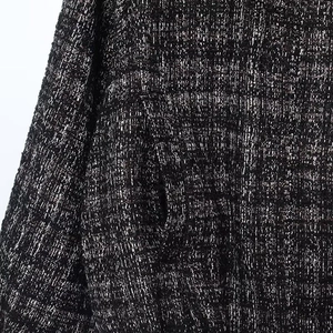 Macro detail of textured tweed fabric with metallic thread and neat pocket stitching