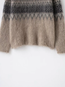 Close-up of vintage geometric jacquard knit sweater with fuzzy mohair texture