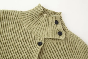 Detail of high neck knit cardigan sweater in sage green with side buttons and ribbed texture
