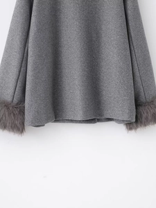 Detail of grey wool coat showing thick fabric texture and faux fur trim on sleeves