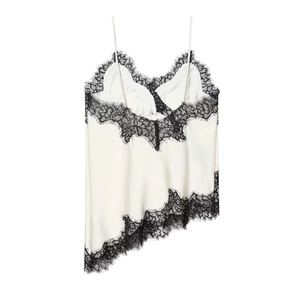 Detail of satin camisole featuring black lace trim and asymmetrical hemline design