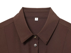 Detailed macro view of dark brown shirt collar, resin buttons and S-size label