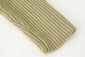 Close-up of light olive green cardigan showing elastic ribbed knit texture and soft fabric