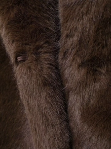 Gros plan détaillé de la texture d'une fausse fourrure marron foncé aux fibres douces