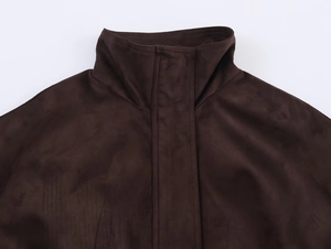 Detail shot of a dark brown faux suede jacket featuring a stand collar and reinforced stitching
