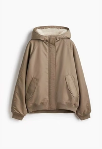 Detail of khaki hooded jacket featuring thick cream fleece lining and windproof fabric