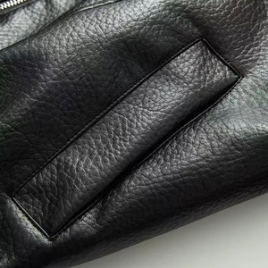 Macro detail of high-quality black leather texture with stitching and metal zipper
