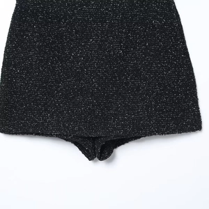Detailed macro view of black tweed textured fabric on high waist tailored skort shorts