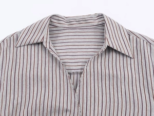 Detail of the vintage striped shirt showing the lapel collar and deep V-neckline texture