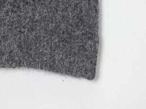 Macro shot of charcoal grey wool blend fabric showing detailed felt fiber texture
