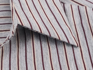 Close-up of the lapel collar on a grey and red vertical striped button-up shirt