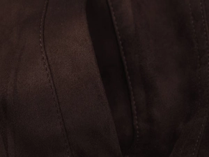 Macro detail of dark brown faux suede jacket fabric with precise parallel stitching