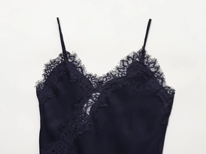 Detail of dark blue satin camisole top with eyelash lace trim and V-neckline