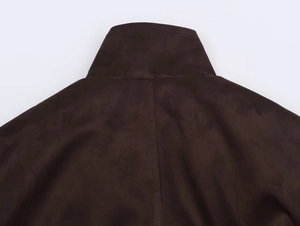 Detail of dark brown faux suede jacket collar with precise stitching and matte finish