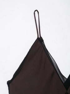 Detail of chocolate satin sleepwear featuring thin straps and black lace mesh trim