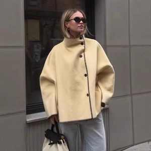 Women's pale yellow wool jacket with high neck, black contrast trim and large buttons