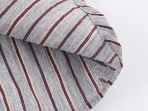 Close-up of high-quality striped fabric texture and neat hem stitching detail