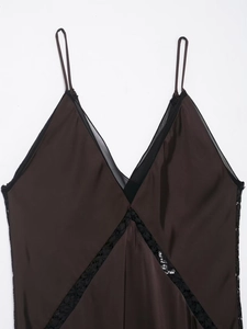 Detailed view of deep brown satin sleepwear with black lace trim and V-neckline