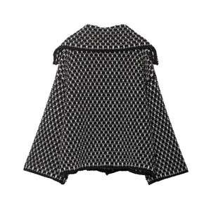 Detailed view of the black and white knitted cardigan with classic textured monogram pattern