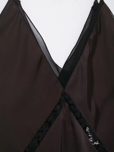 Detail of dark brown satin nightdress with deep V-neck and delicate black lace trim