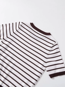 Detail of the crew neckline and shoulder seams on the striped knit short-sleeve top