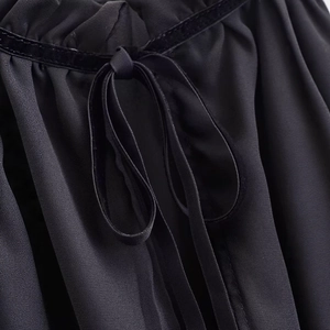 Vintage black autumn blouse featuring ruffled texture and velvet bow tie detail