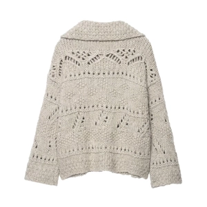 Detailed back view of a loose chunky knit cardigan featuring openwork patterns and a wide lapel