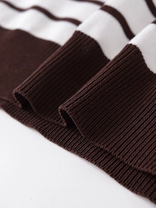 Close-up of brown and white striped knit top showing ribbed cuffs and soft texture