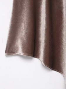 Detail shot of dusty pink velvet fabric showing soft texture and single-stitch hem finish
