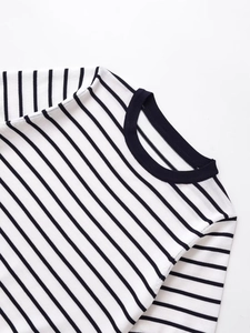 Detailed view of neckline and fabric texture on black and white striped knit top