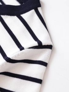 Close-up of black and white striped knitwear showing fine stitching and fabric texture