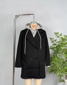 Detail of a black double-breasted long coat with a detachable grey drawstring hood