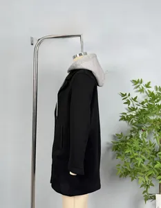 Detail view of a long black hooded coat with a grey layered drawstring hood and side pockets