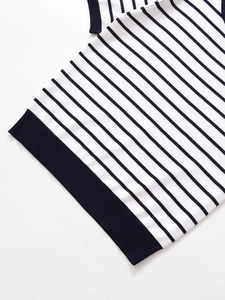 Detail of navy and white striped knitwear showing high-quality ribbed hem texture