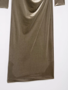 Detailed view of olive green velvet dress featuring shimmering fabric and pleated hemline