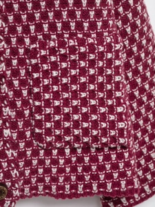 Detail of wine red plaid knit cardigan with textured pocket and vintage metal button