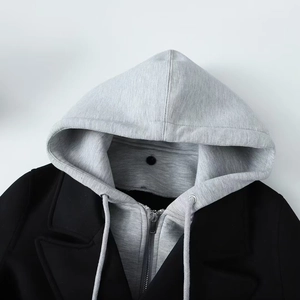 Women's black long coat with a grey detachable drawstring hood and metal zipper