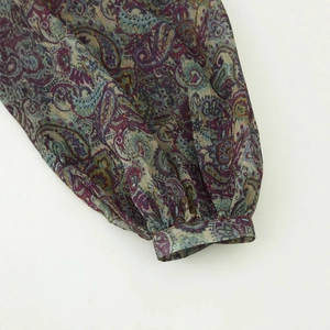 Metallic paisley print mini dress featuring long lantern sleeves with ruffled cuffs