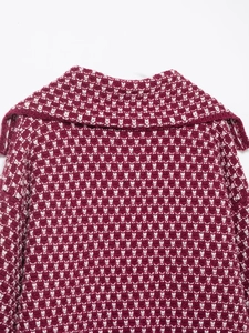Close-up of red and white jacquard knit pattern featuring rabbit motifs and a wide collar