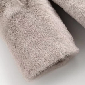 Macro detail of plush faux mink fur sleeve showing soft texture in light grey-purple