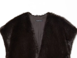 Detail of the high-quality faux fur texture and brand label on the sleeveless vest