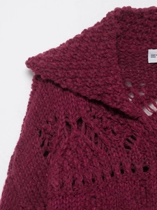 Detail of burgundy chunky knit cardigan featuring hollow-out texture and lapel collar