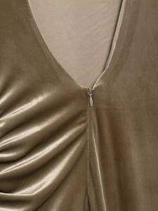 Detail of deep V-neckline with invisible zipper on dark olive green velvet dress