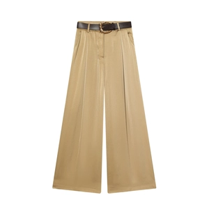 Detail of high-waisted satin wide-leg trousers in champagne gold with a slim brown belt