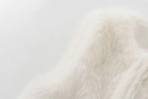 Close-up of the plush and soft faux fur texture on this stylish white winter vest