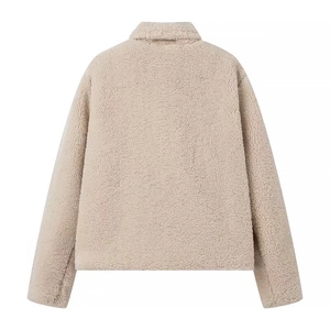 Back view detail of beige sherpa fleece jacket with textured finish and turn-down collar