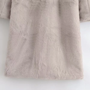 Close-up of the plush faux fur texture and stitching details of the grey winter coat