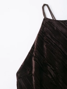 Detail of dark brown velvet fabric texture with delicate spaghetti straps and subtle sheen